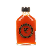 FLAGRANT SAUCE hot sauce bottle with black cap, orange-red sauce, front label