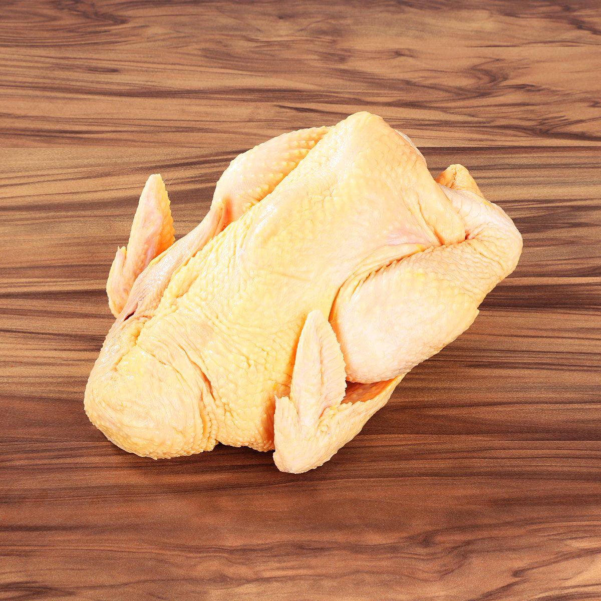 Raw whole chicken with pale yellow skin