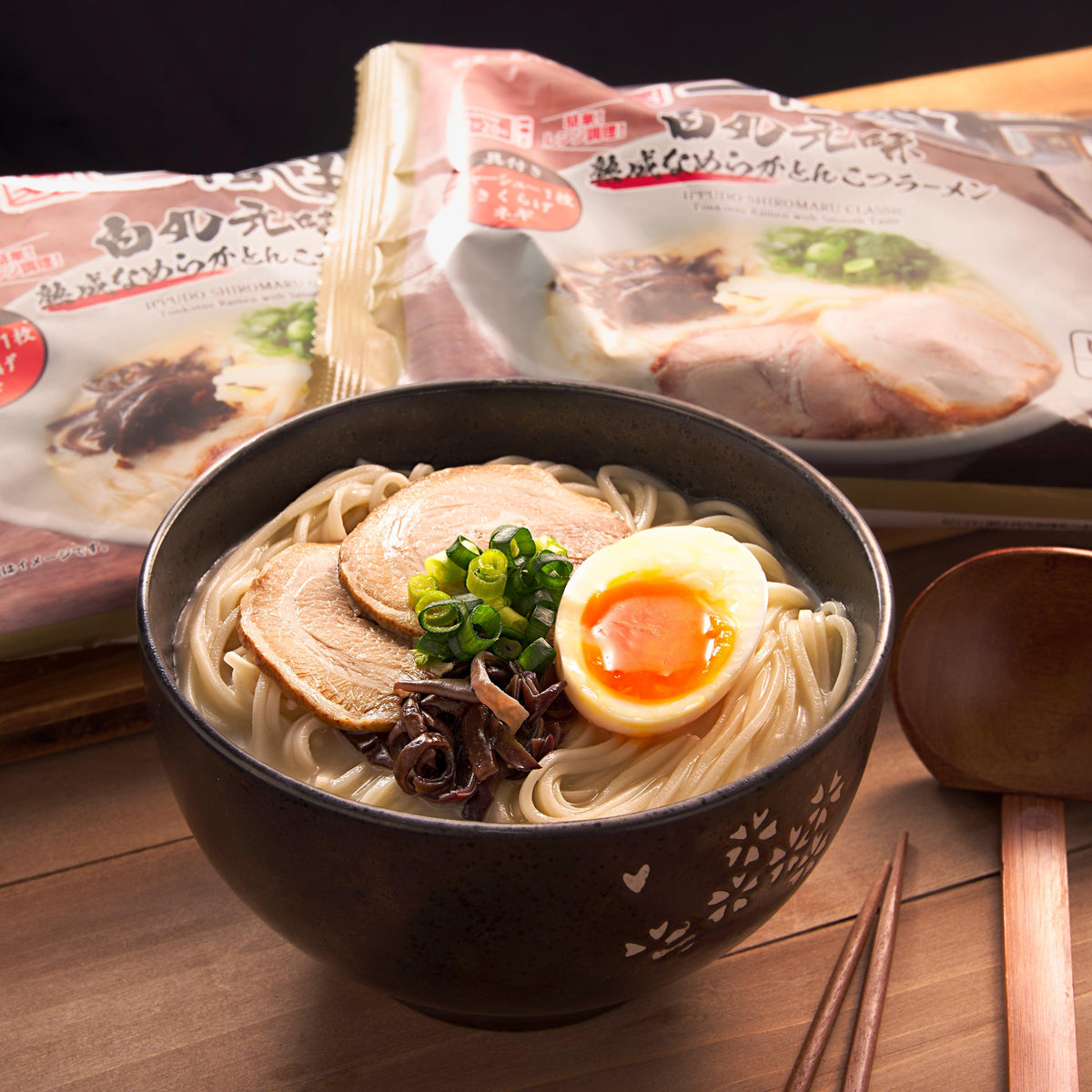Bowl of ramen with noodles, sliced pork, soft egg, scallions, and mushrooms