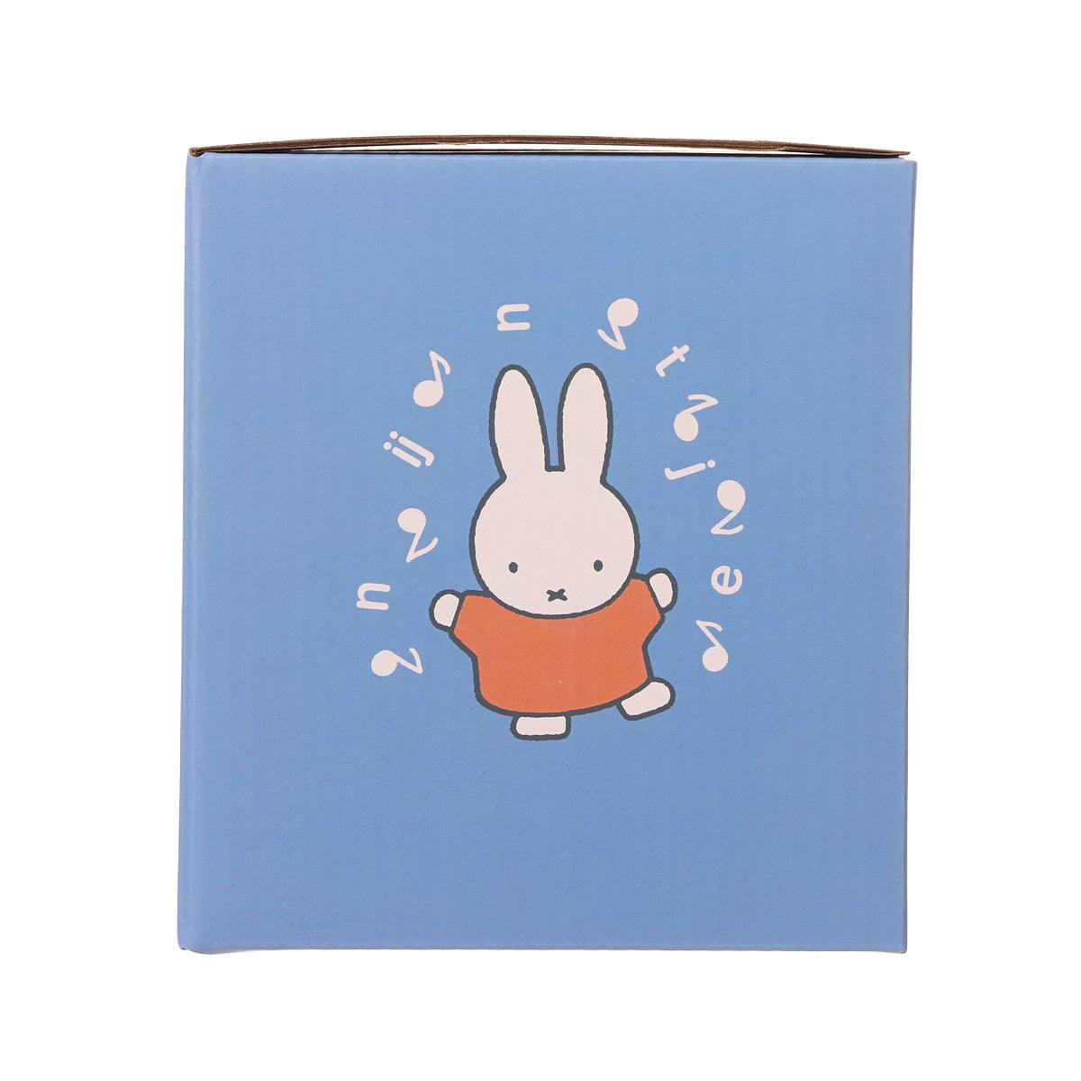 Blue Miffy rolling Christmas music box with rabbit in orange outfit and floating music notes
