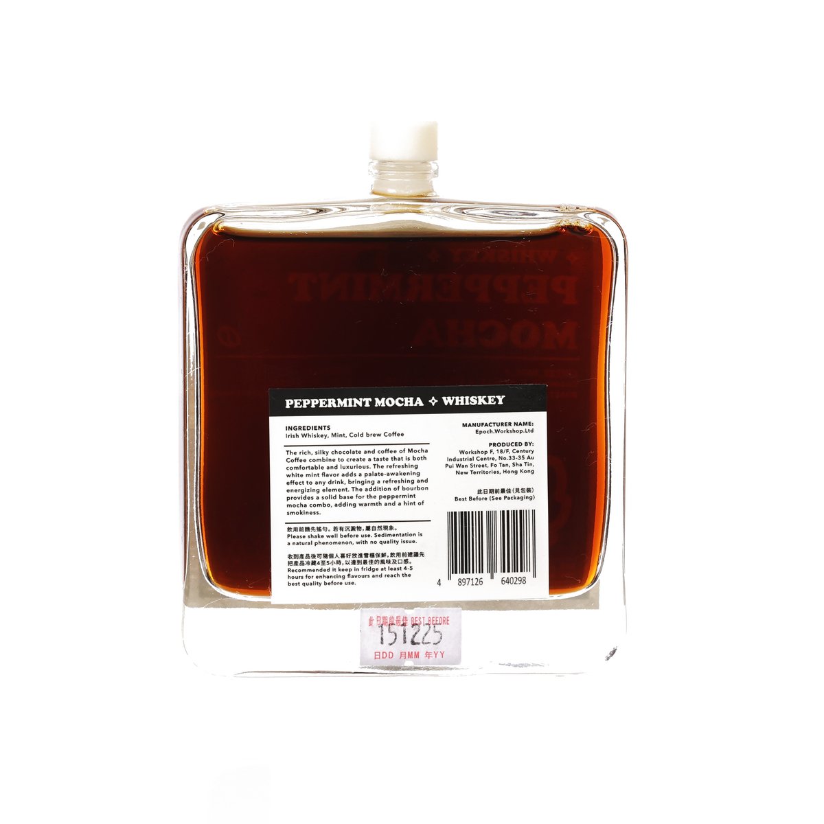 Back of whiskey cocktail bottle with barcode label, amber-brown liquid in glass