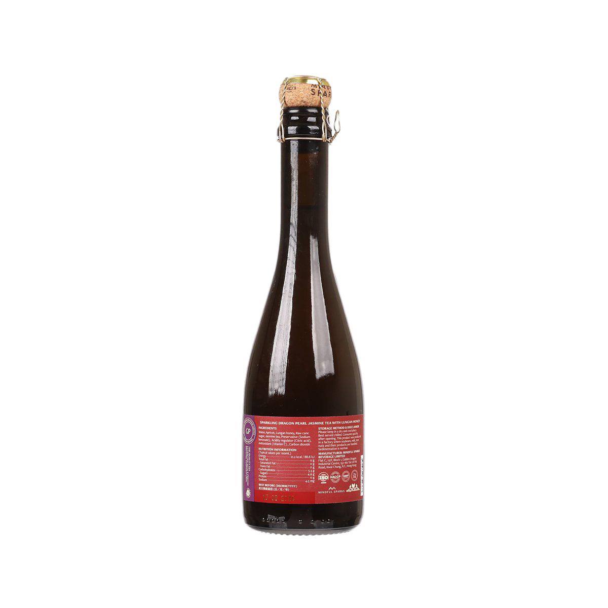 Sparkling tea bottle, dark amber glass with back red info label and cork cap
