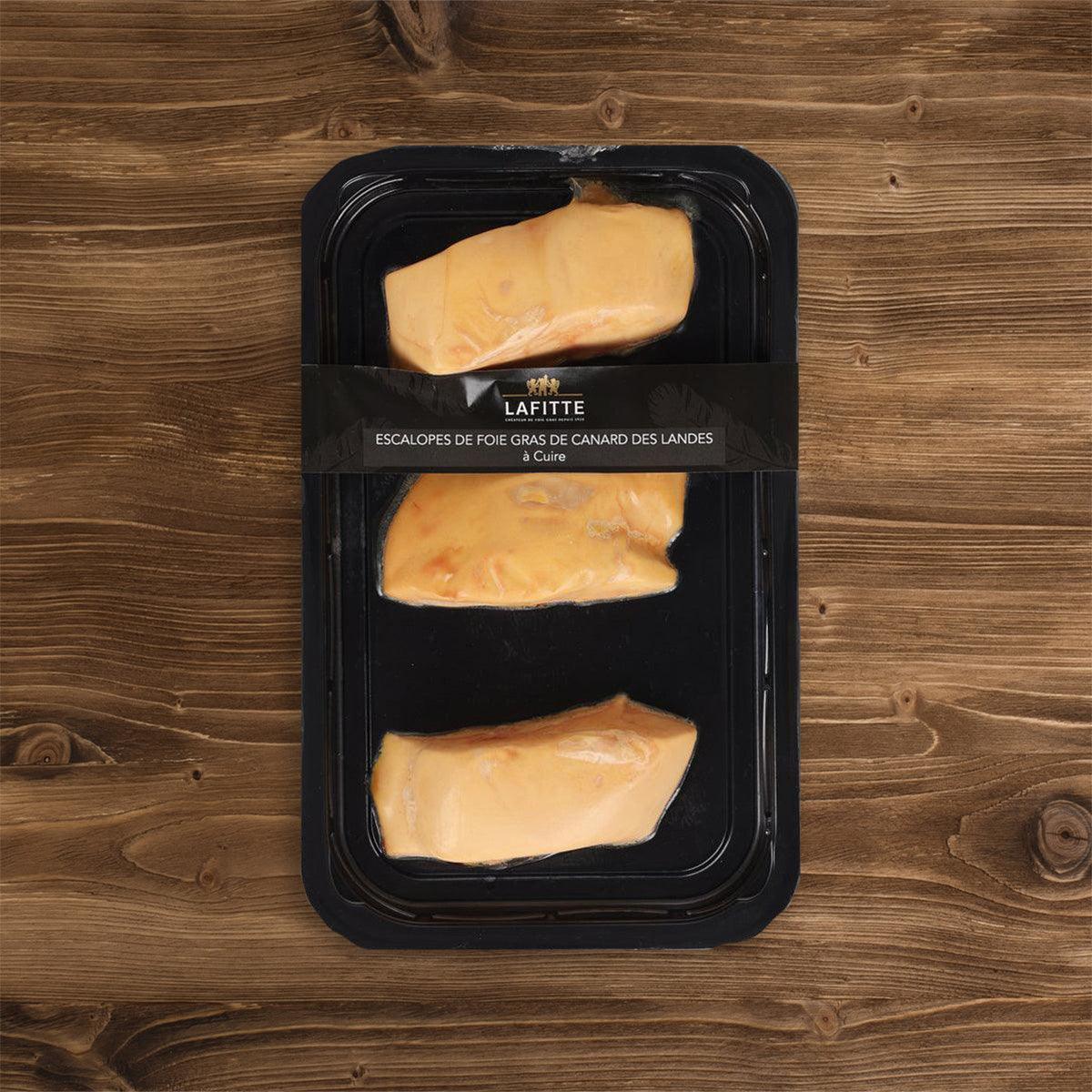 Chilled duck foie gras portions in black plastic tray, three sealed slices