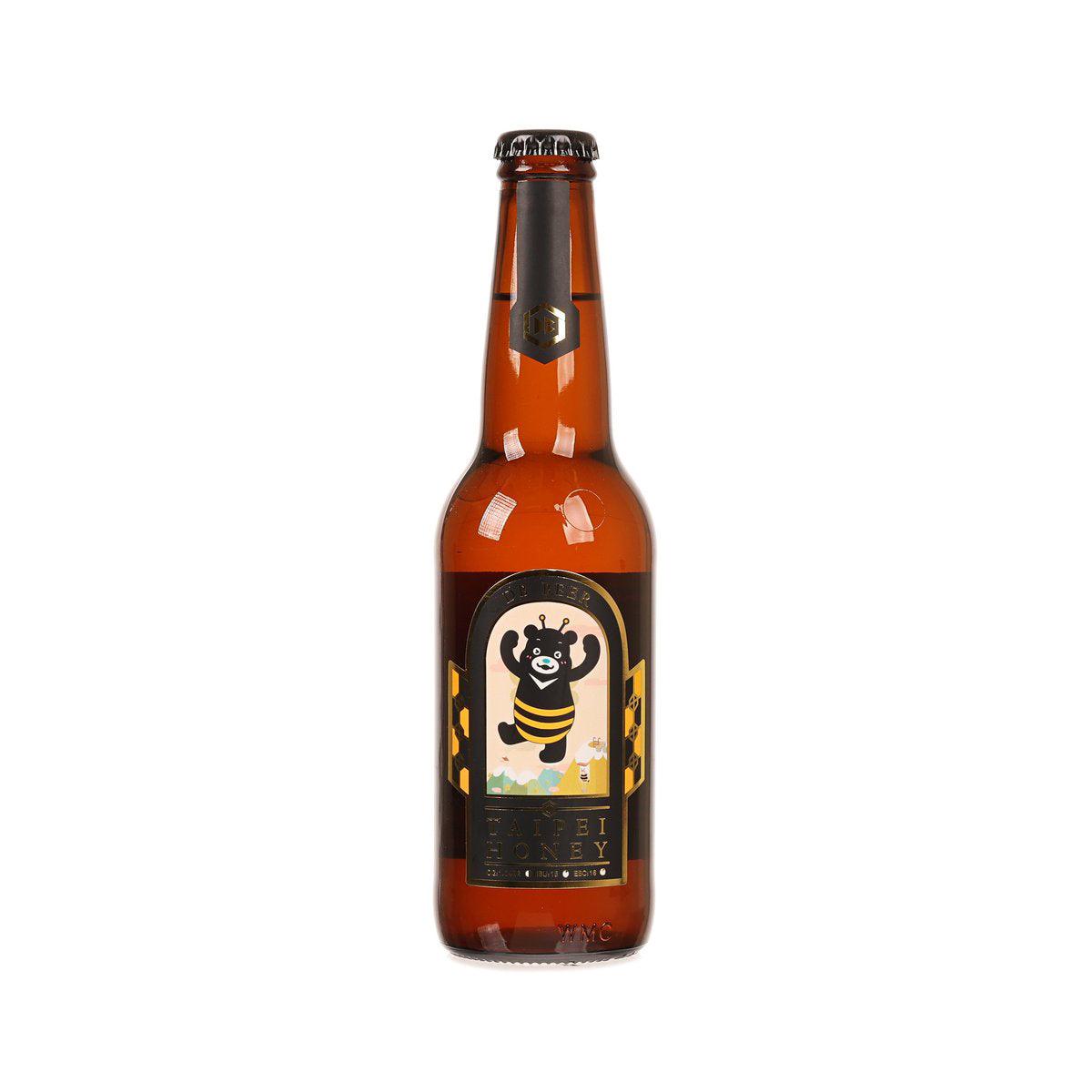 Amber honey lager beer bottle with front label and gold-toned cap