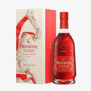 Cognac bottle in red with red cap and label, beside illustrated CNY gift box