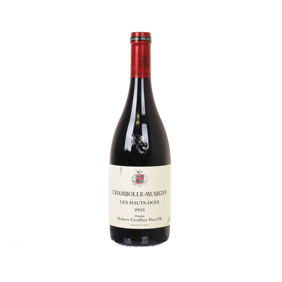 Chambolle Musigny wine bottle with red foil cap and front label on dark glass