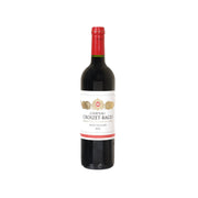 Bordeaux wine bottle with red foil, dark glass, and front label