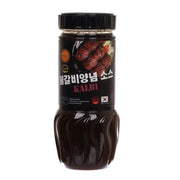 Kalbi marinade sauce bottle, dark brown with black cap; front label and grill image.