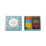 Assorted sandwich cookie gift box with patterned lid; open tray shows colorful cookie bars