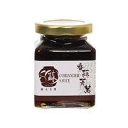 Coriander sauce jar with gold lid, dark amber contents, front label