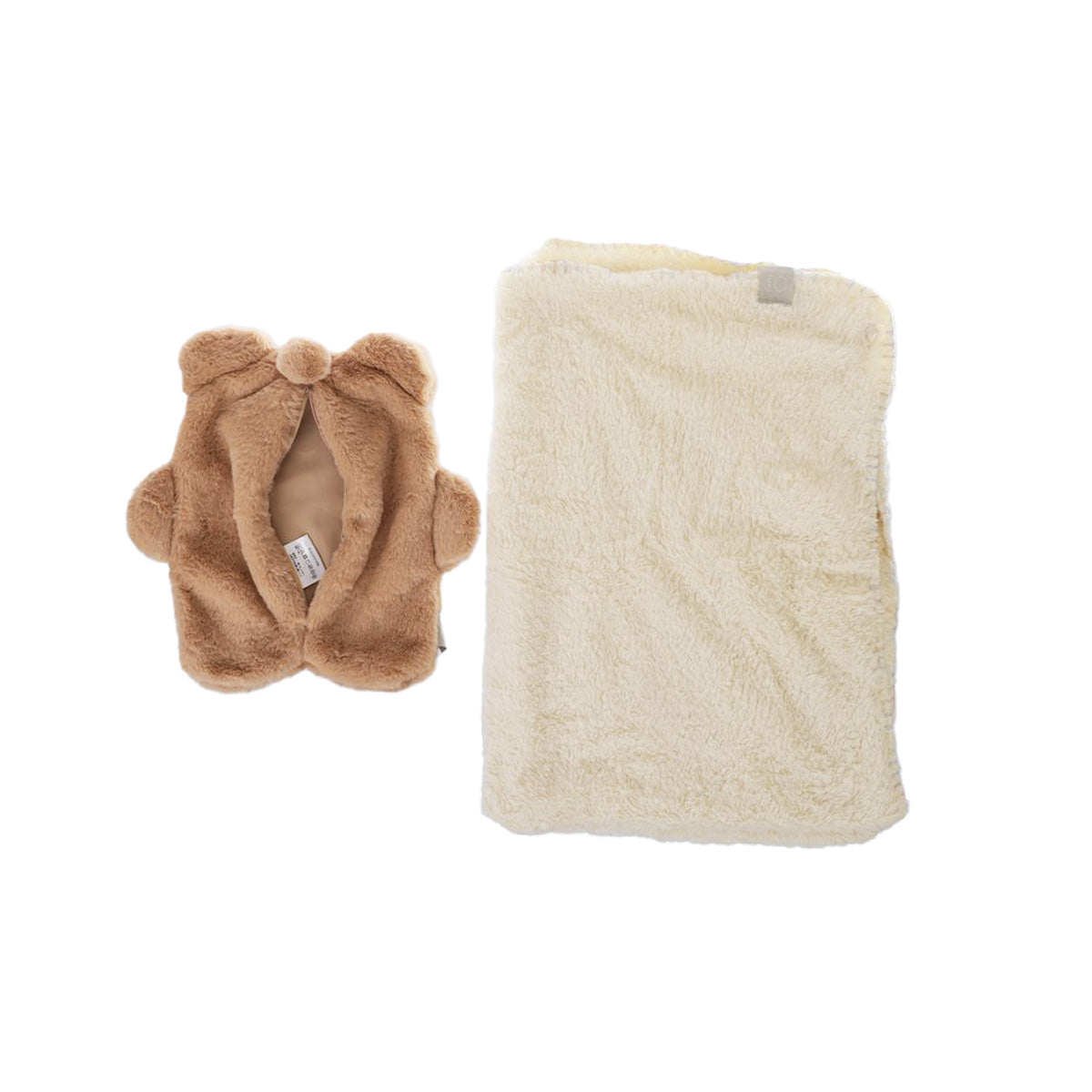 Folded cream blanket with strap, inside bear-shaped pouch