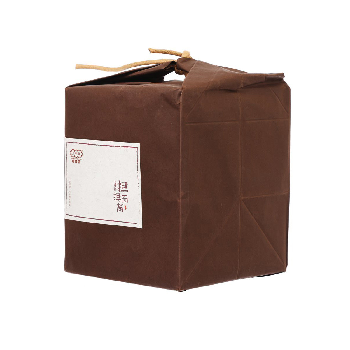 Brown paper-wrapped sauce package corner view with twine tie and side folds