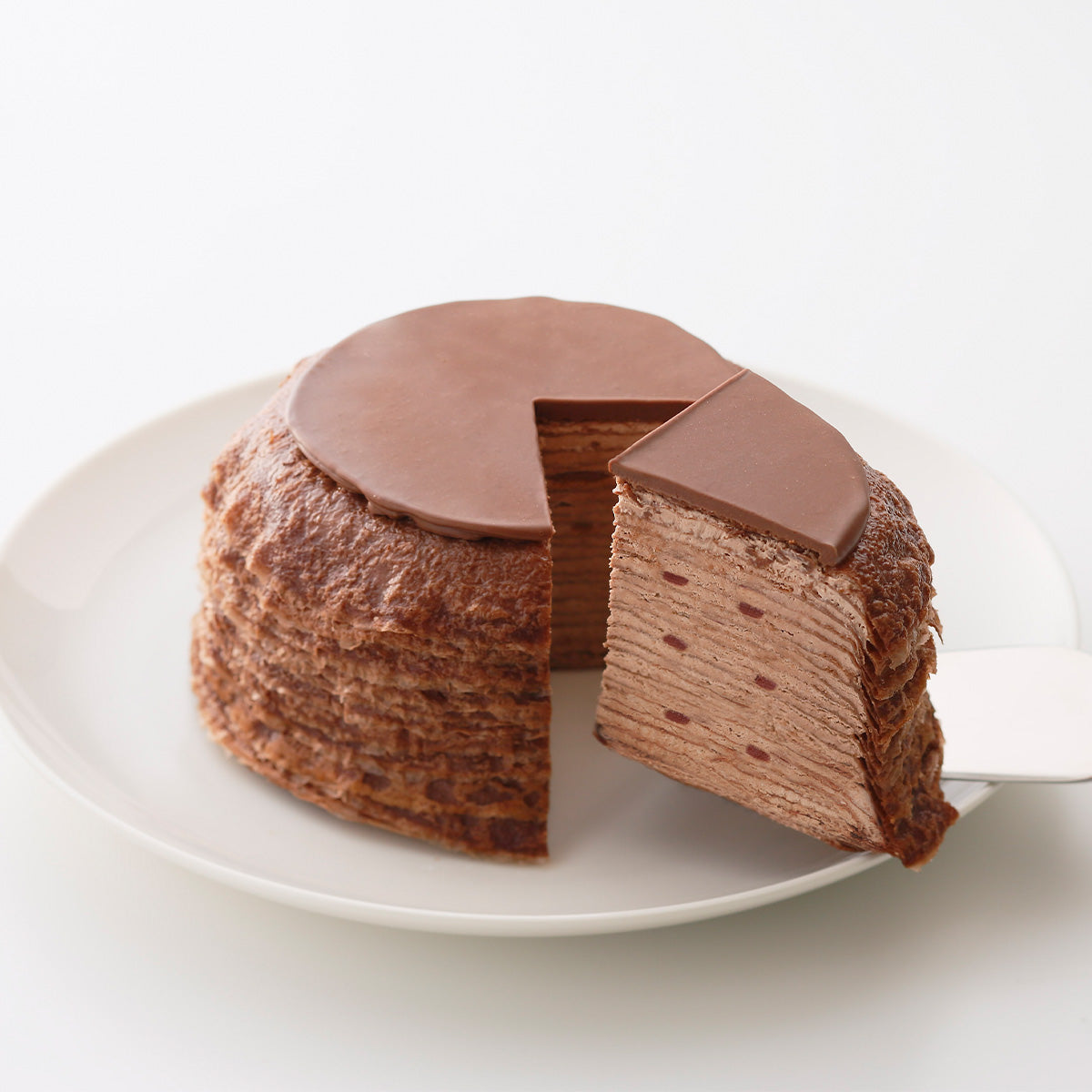 SUZETTE double chocolate mille-crêpe cake, sliced on a white plate