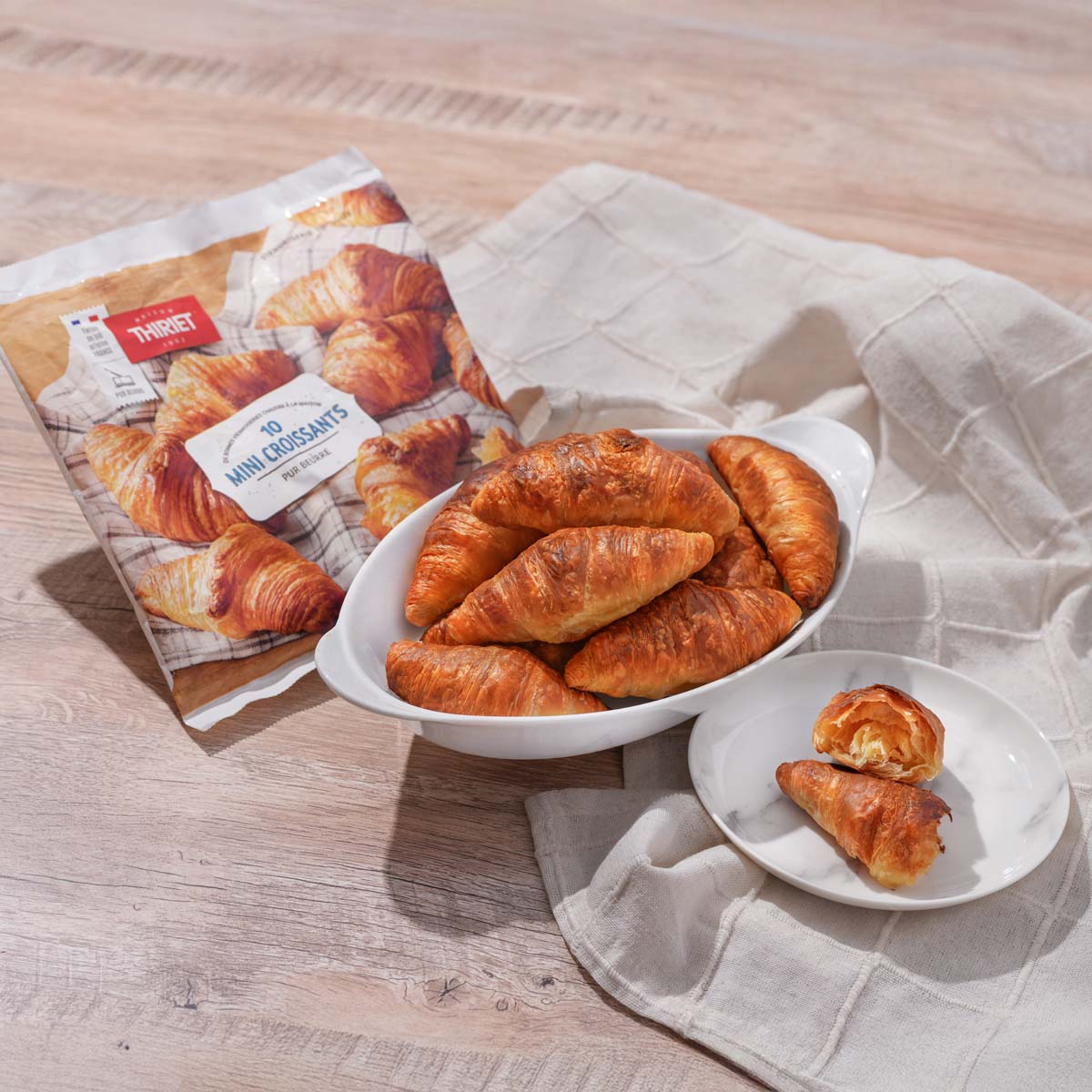 Mini croissants with pure butter in white dishes beside THIRIET 300g bag