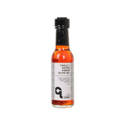 Chilli extra virgin olive oil dressing bottle with black cap and orange glass
