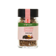 Glass jar of cumin seeds with black cap and front green seasoning label