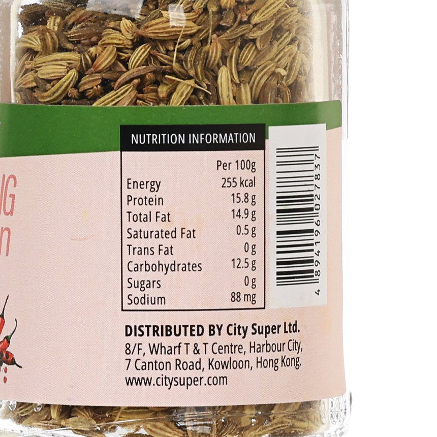 Close-up of nutrition label on fennel seed seasoning jar, glass with fennel seeds