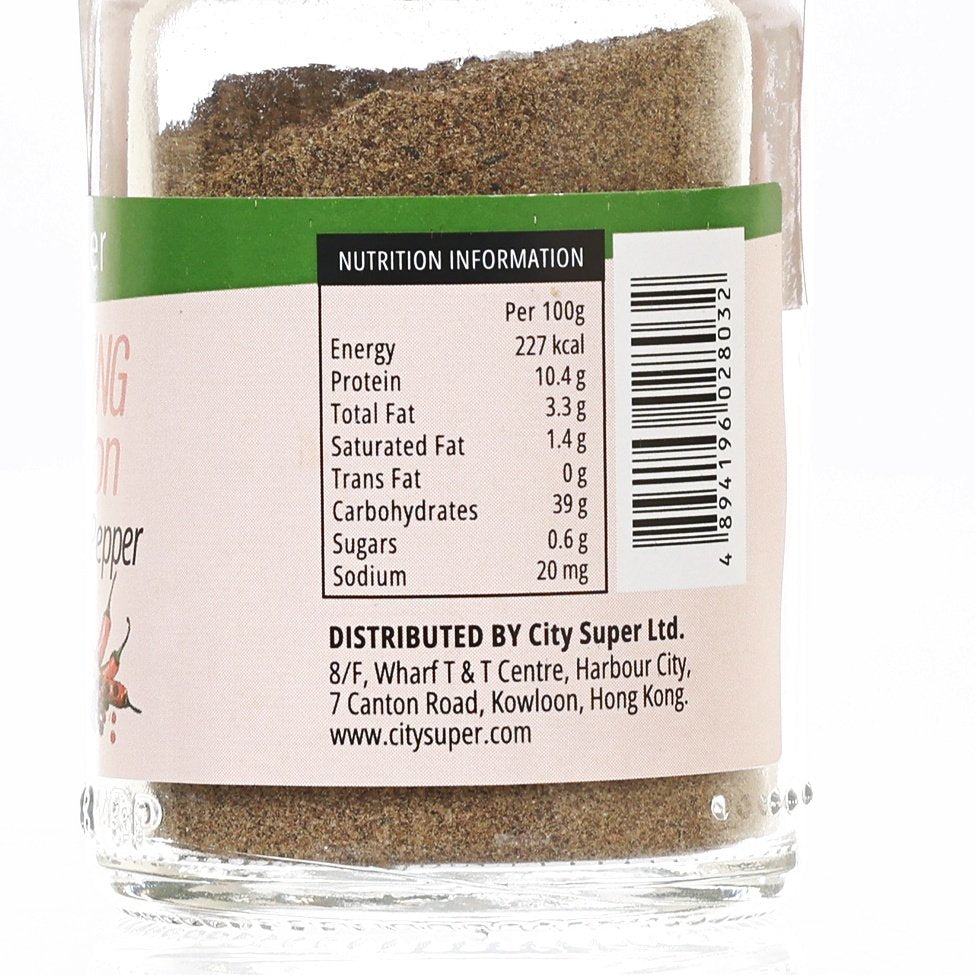 Ground black pepper nutrition information label on a clear glass seasoning jar