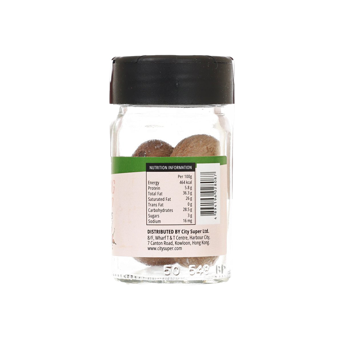 Whole nutmeg seasoning jar showing nutrition label on clear glass