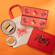 Gift box set with red boxes, ribbon, and square cookies on plates