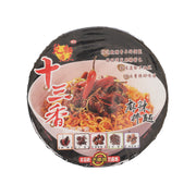 Instant noodle bowl cup with black and red artwork, spicy noodles pictured on front