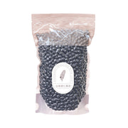 Black beans in clear plastic pouch with paper label