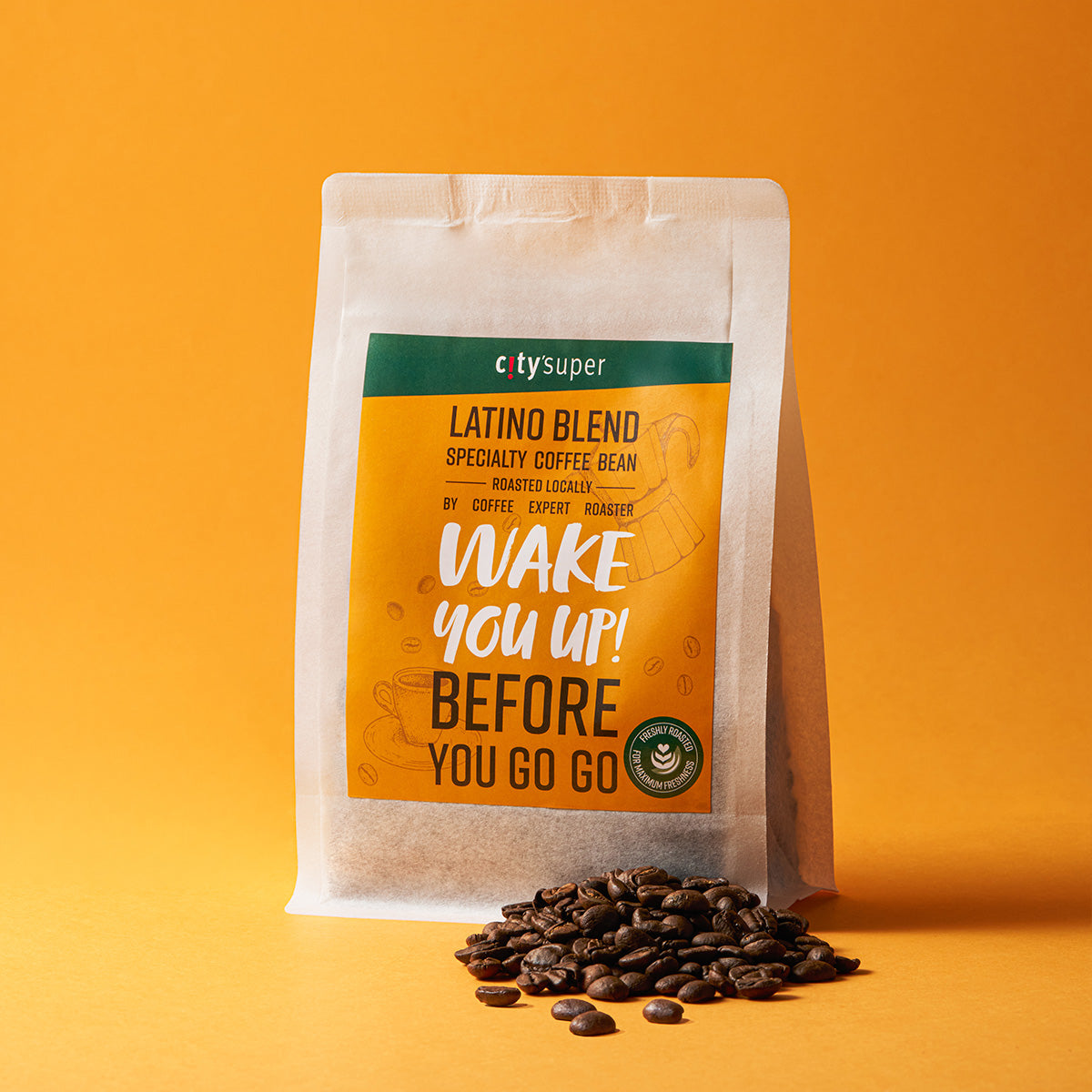 Specialty whole coffee bean bag with orange-green front label and scattered whole beans