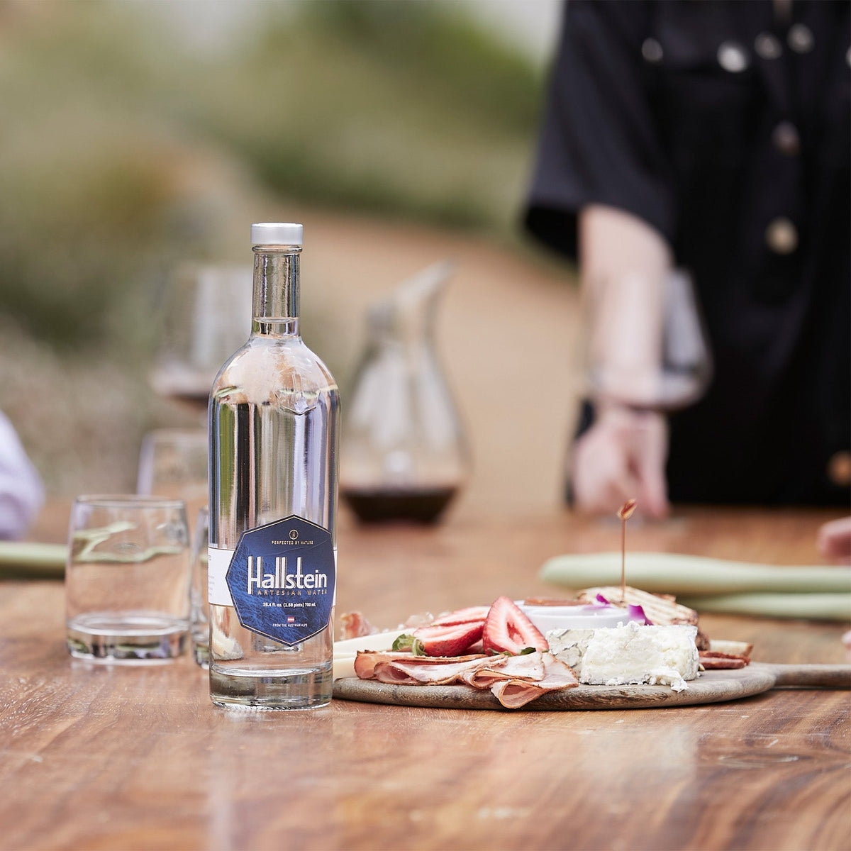 Artesian water bottle on a wooden table with blue label