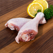 Frozen chicken drumsticks, pale skin-on pieces