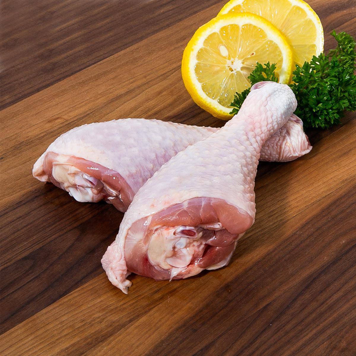 Frozen chicken drumsticks, pale skin-on pieces