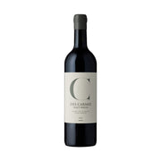 Wine bottle with dark glass and cream label, green letter C, vintage 2021.