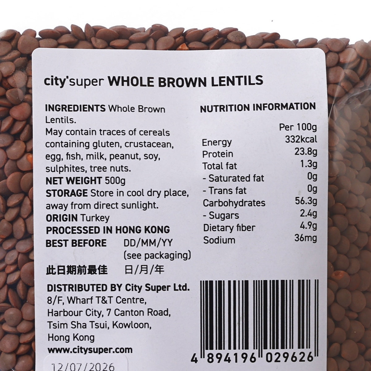 Whole brown lentils label close-up on bag, nutrition and barcode