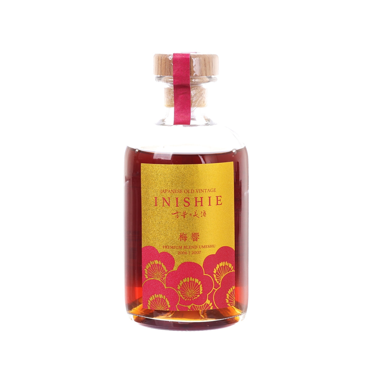Ume liqueur bottle with red floral label, clear glass, and ribbon-tied cork stopper.