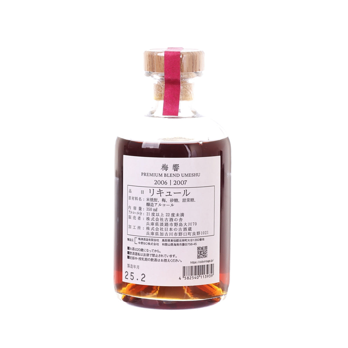 Ume liqueur bottle with back label text, clear glass, and ribbon-tied cork stopper.