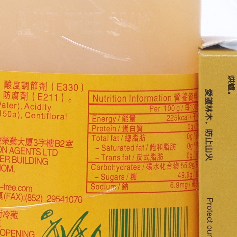 Nutrition facts label on barbecue honey syrup bottle beside cardboard box