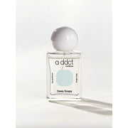 Eau de parfum bottle with clear glass, rounded cap, and addct mellow label