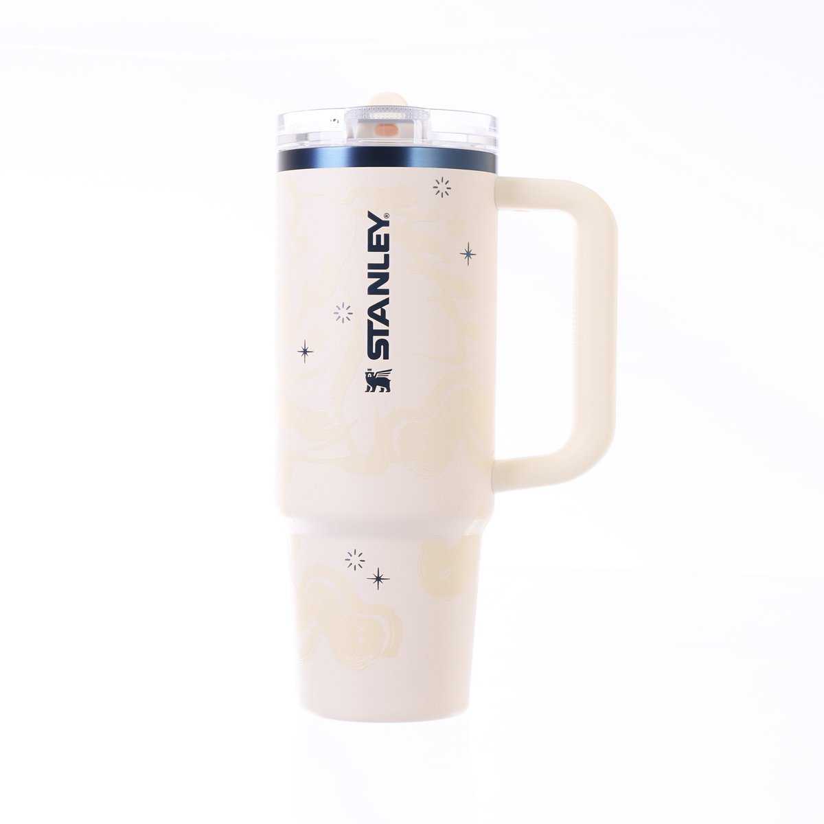 Cream STANLEY tumbler with flip straw lid, clear top, and side emblem
