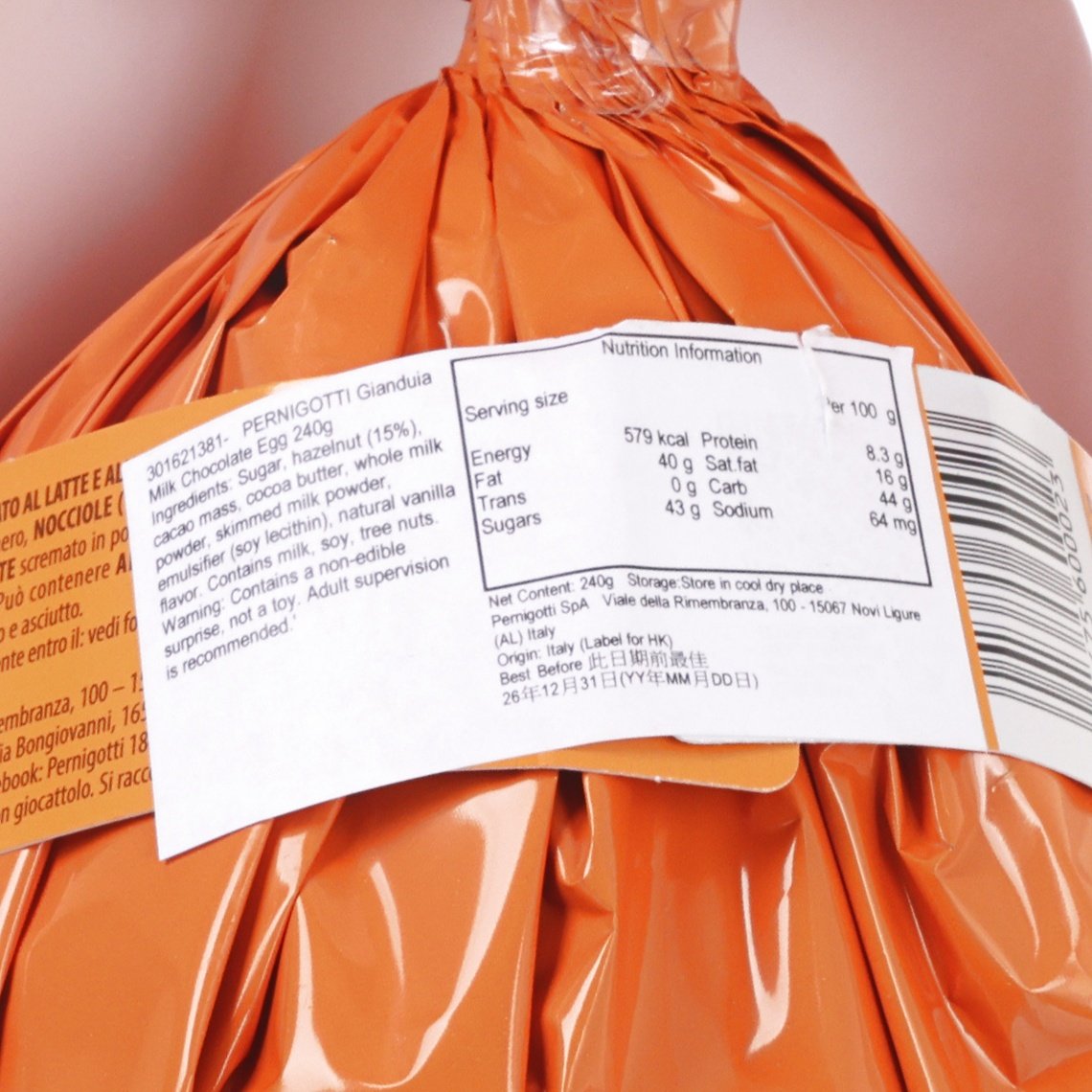 Wrapped gianduia milk chocolate egg with nutrition facts label on orange foil