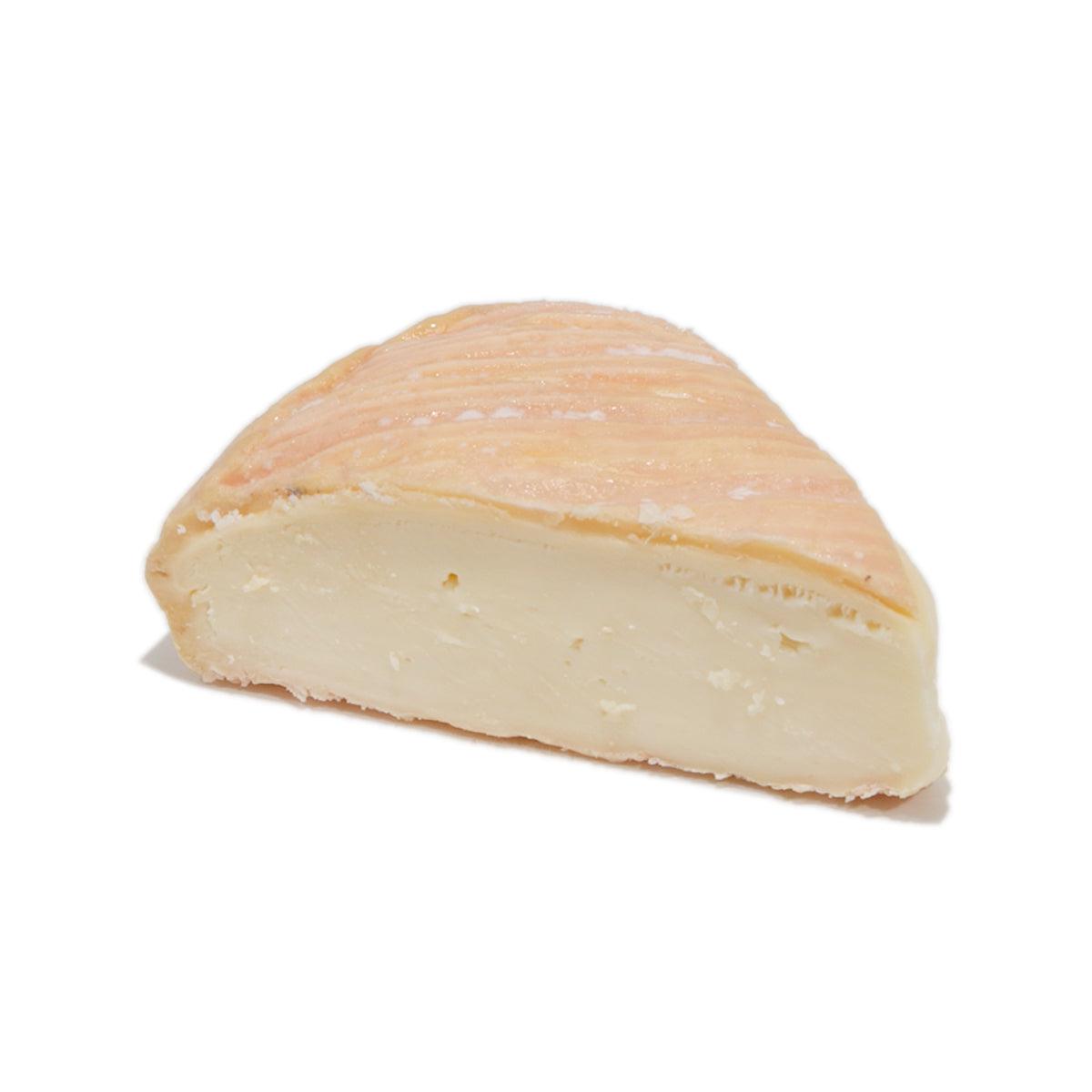Munster cheese wedge with light orange rind and pale creamy interior, 150g