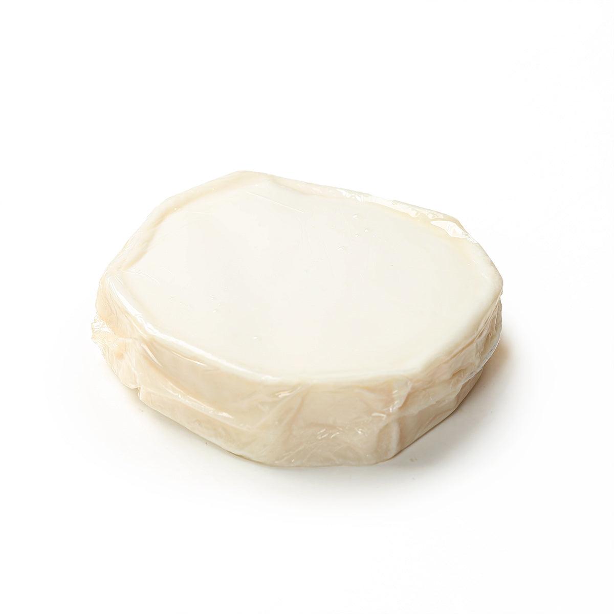 SOIGNON matured white goat cheese, creamy pale block with rind