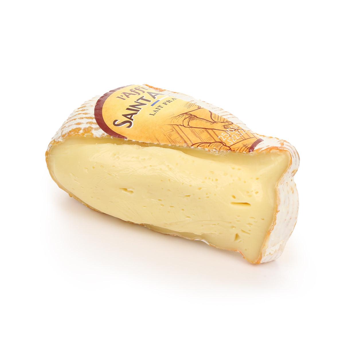 Full fat soft cheese wedge with exposed pale interior and crumbled rind