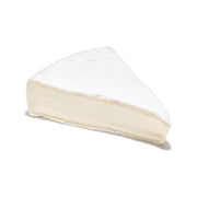 Brie cheese wedge with white rind and pale creamy interior