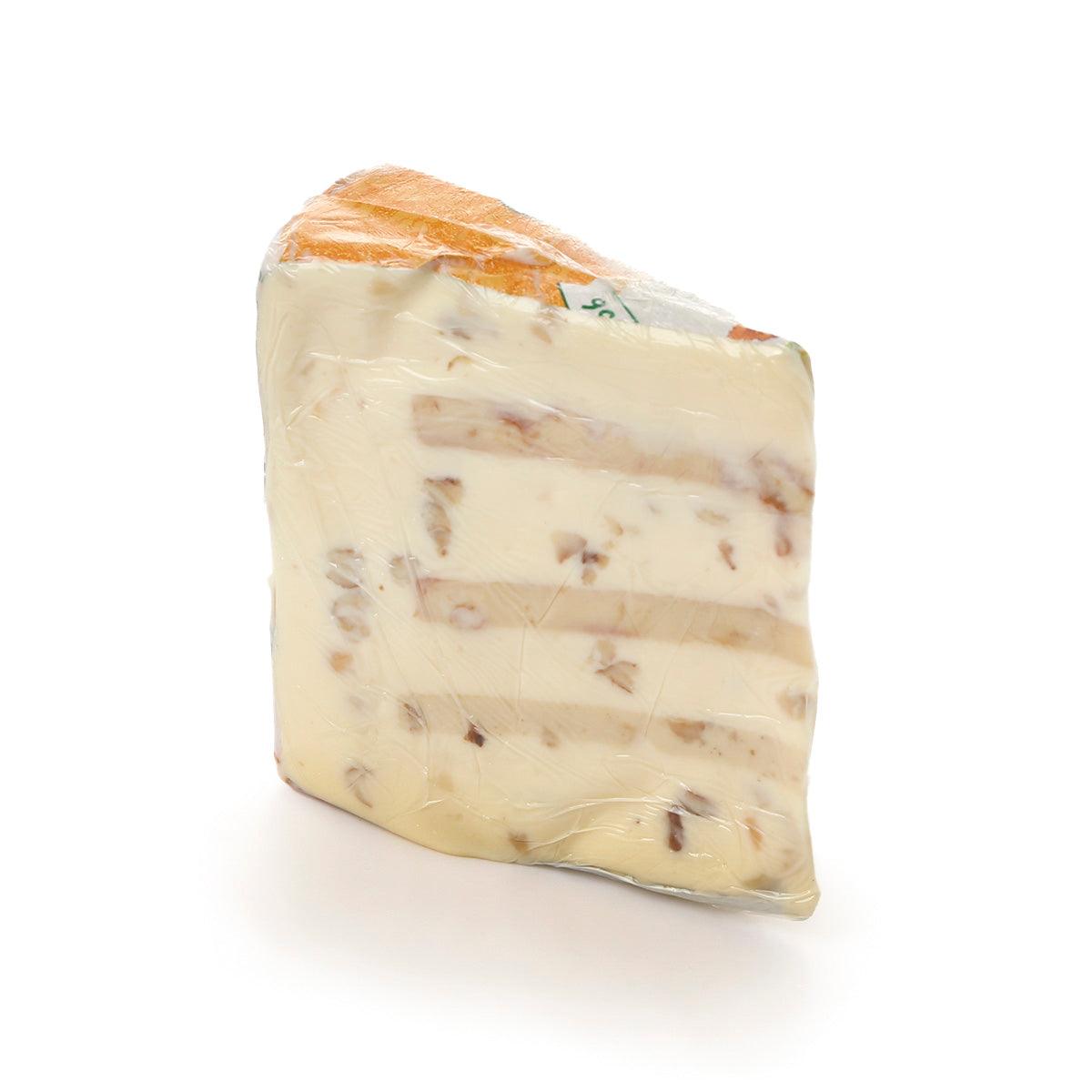 Cheese wedge with walnut pieces, pale yellow and creamy interior