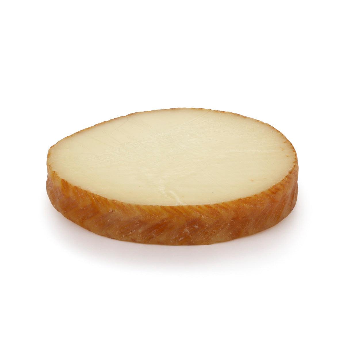 Round milk cheese wheel, sliced face, pale interior with brown rind (150g)