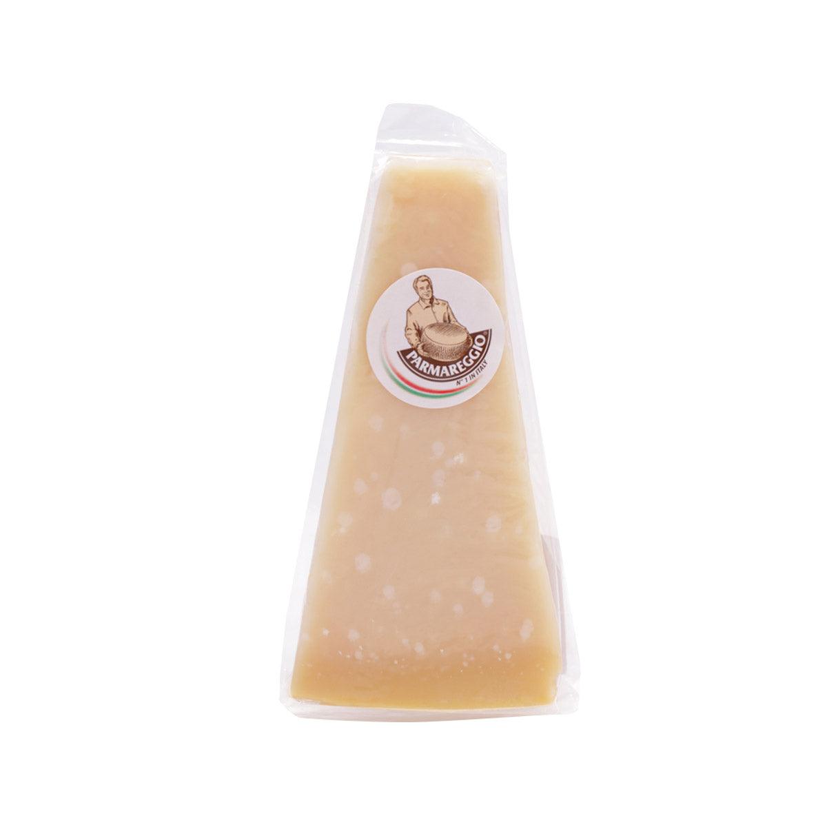 Wedge of aged hard cheese in clear plastic wrap with PARMAREGGIO round label