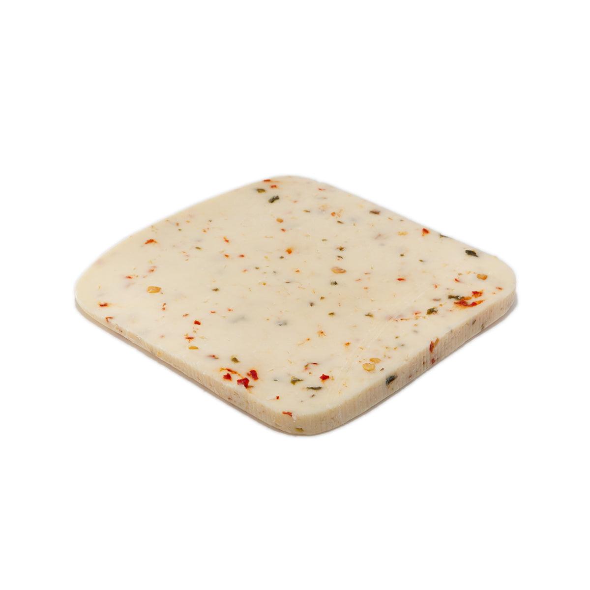 Jalapeno havarti cheese slice with small green and red pepper flakes