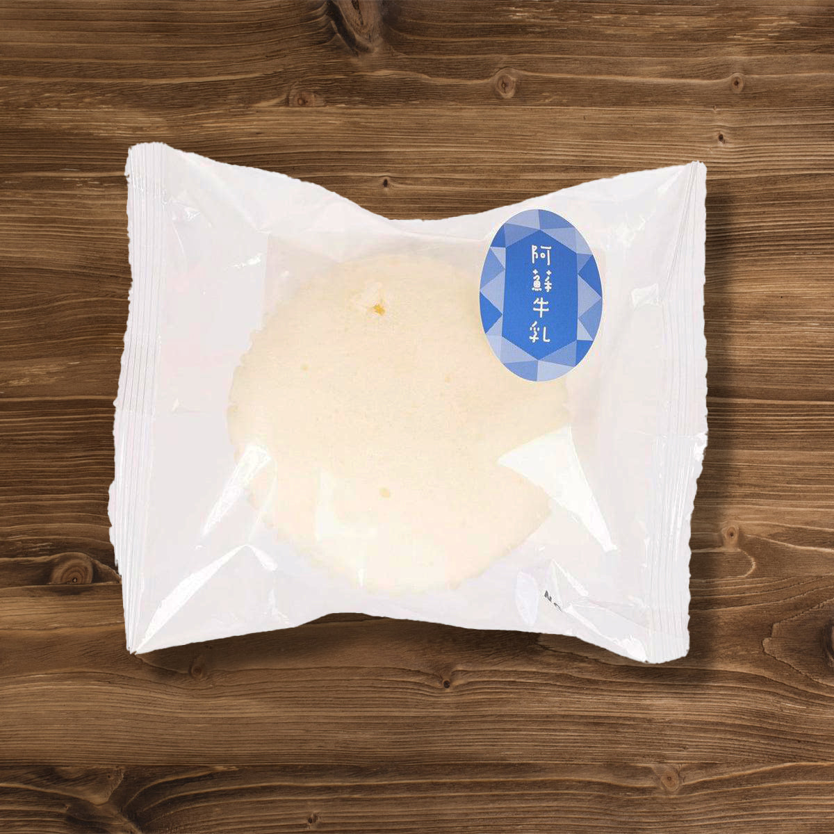 Steamed milk cake in white plastic package, blue label on front