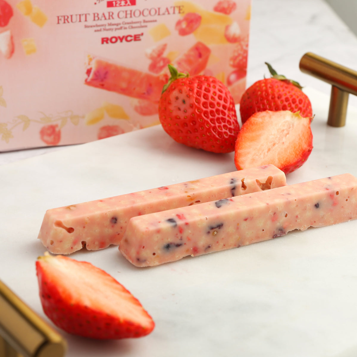 Strawberry fruit bar chocolate bars with visible fruit bits and sliced strawberries.
