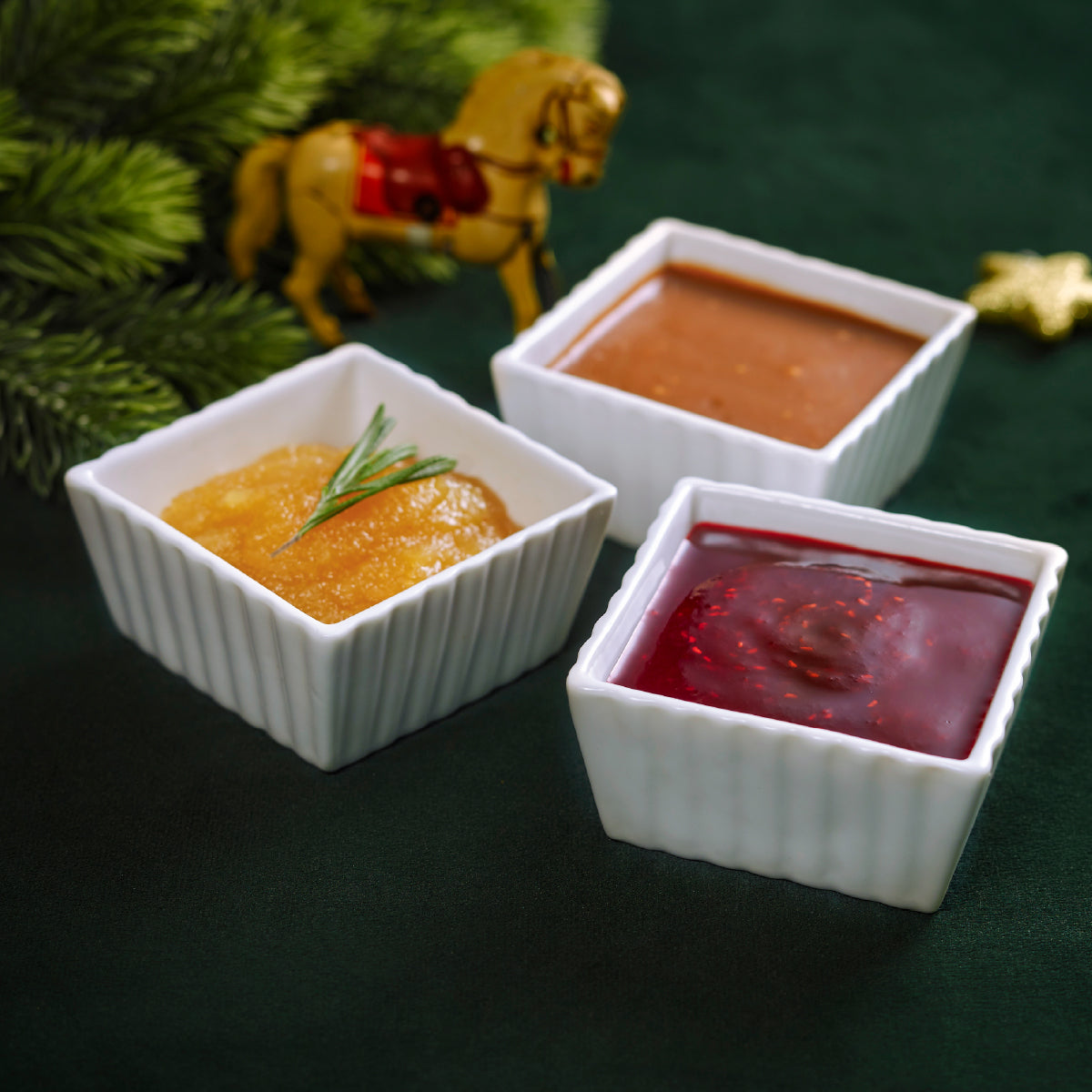 Sauce combo set with three mini white ramekins filled with orange, red, and yellow sauces