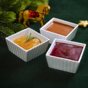 Sauce combo set with three mini white ramekins filled with orange, red, and yellow sauces
